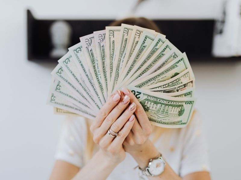 Entrepreneur holding pile of dollars