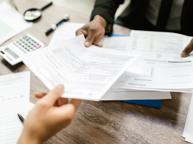 Business owner reviewing financial documents for startup wind down.