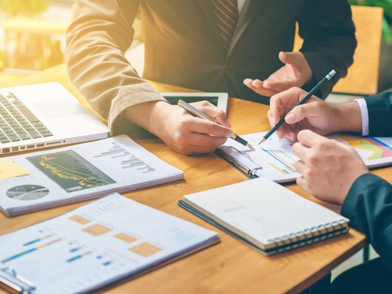 Businessmen analyzing and planning for M&A deals.